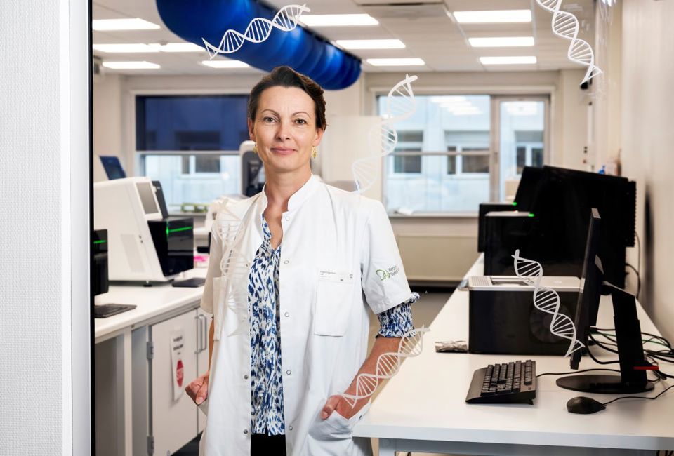 Kvindelig læge i hvid kittel står i et laboratorium