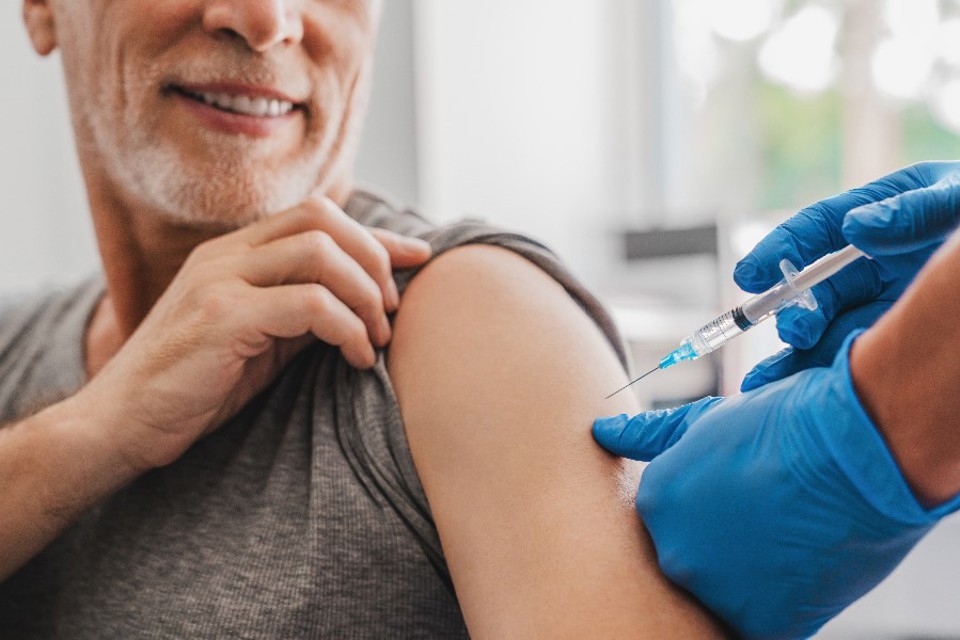 Billede af mand, der bliver vaccineret i venstre skulder