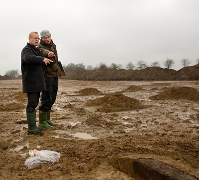 Carl Holst i Jelling - her sammen med Steen Wulff Andersen Regionsrådsformand Carl Holst (t.v.) og museumsinspektør  Steen Wulff Andersen studerer stolpehuller i udgravningen  i Jelling. Foto: Jørgen Diswal